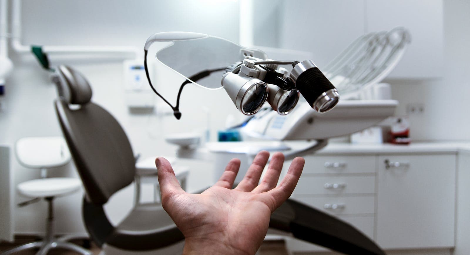 Almanya'da Diş Hekimliği'nde dişçi koltuğuna uzanan bir el.